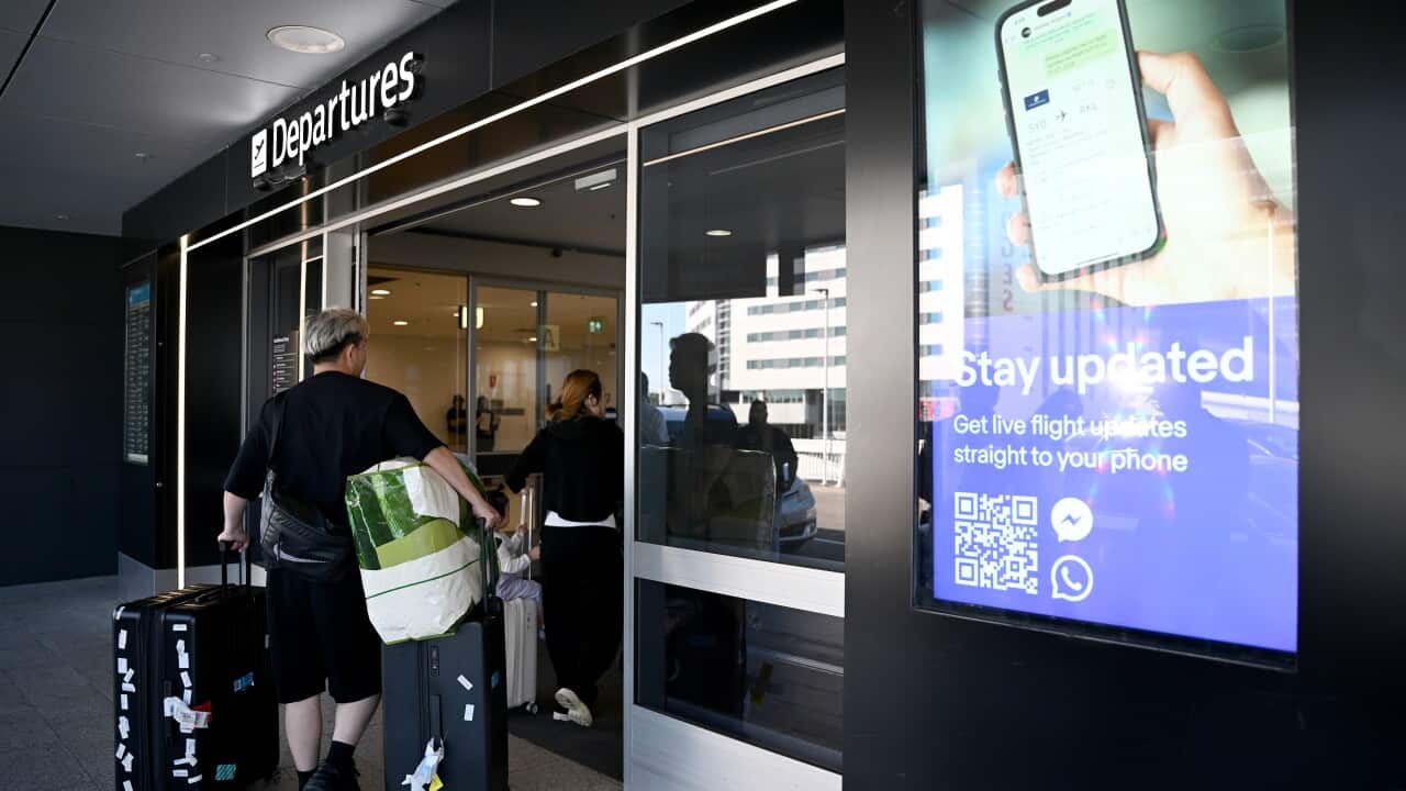Travellers are seen at the Departures terminal of the Sydney International Airport