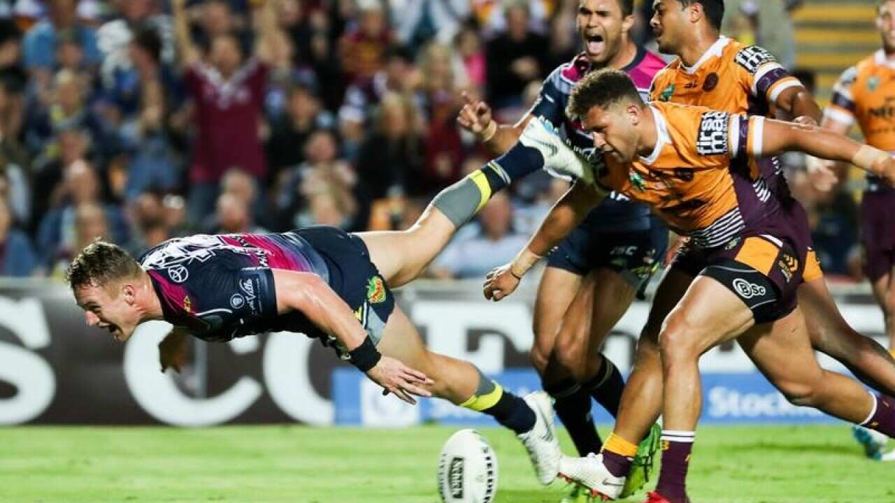 Coen Hess of the Cowboys scores the game winning try