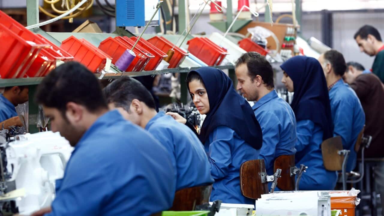Iranian workers in a sewing machine industrial factory