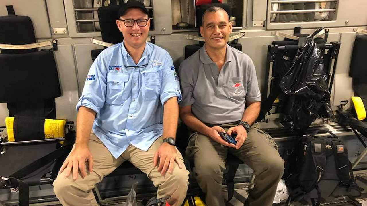 Doctor Richard Harris, left, and diver Craig Challen on their way home on board an RAAF C17.