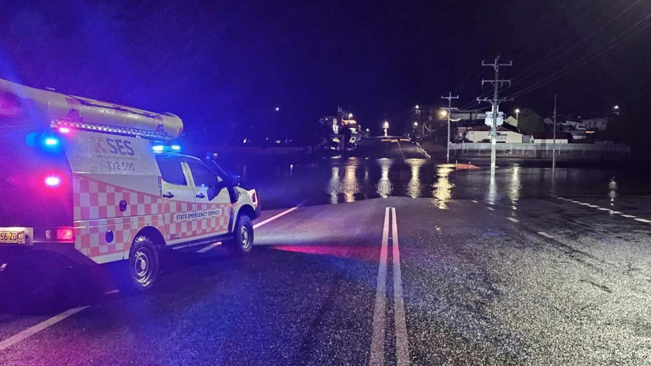 An emergency truck on a flooded road.