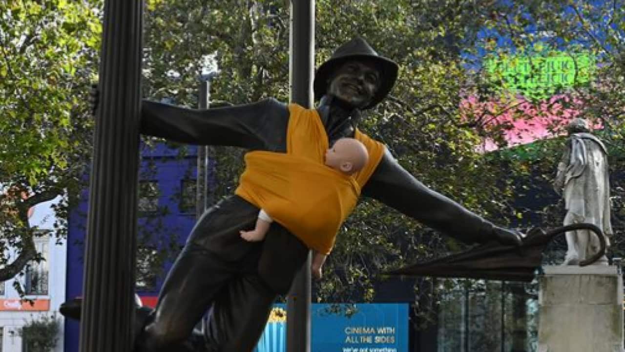Why toy babies are being strapped to statues of men in this country