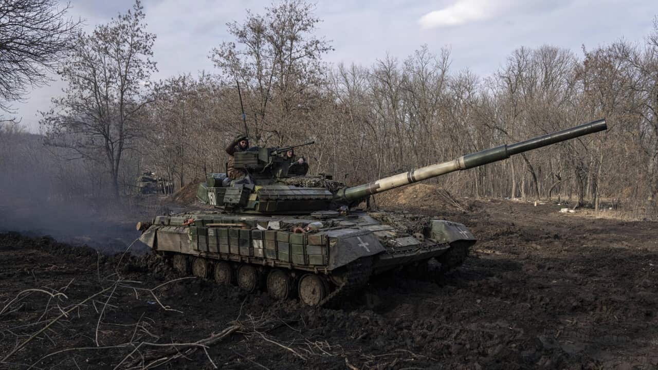 A Ukrainian tank heads towards the frontline near Bakhmut (AAP).jpg