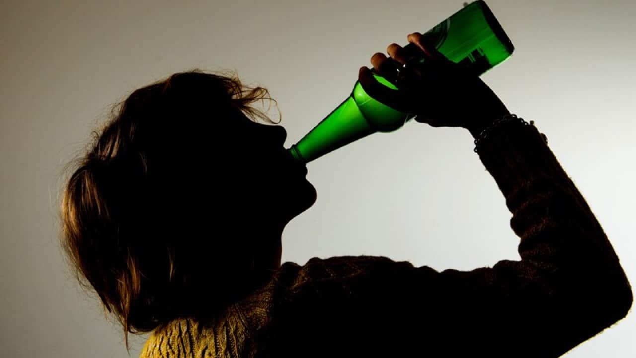A woman drinking alcohol