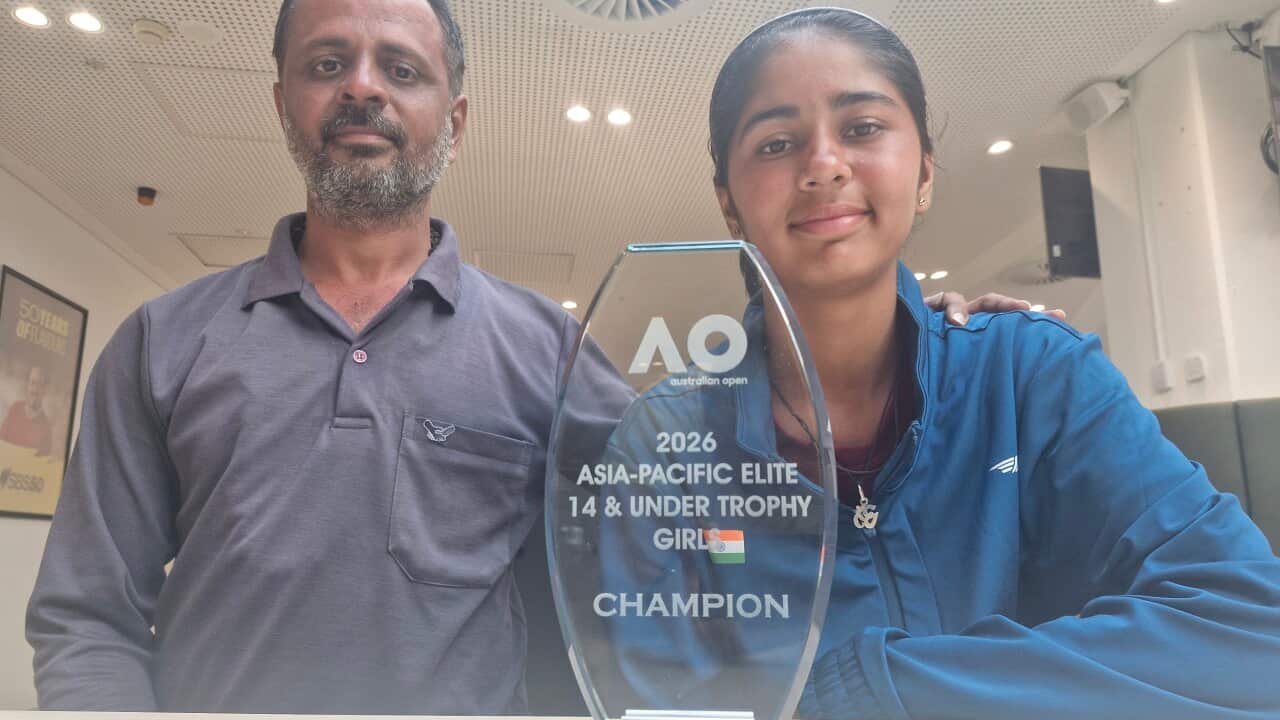 Tennis player Jensi Kanabar (R) pose with the trophy with her father, Dipak Kanabar (L)