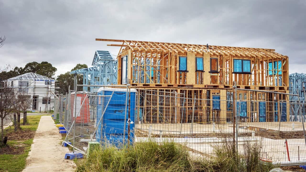 New houses timber construction frame, overcast sky, housing development