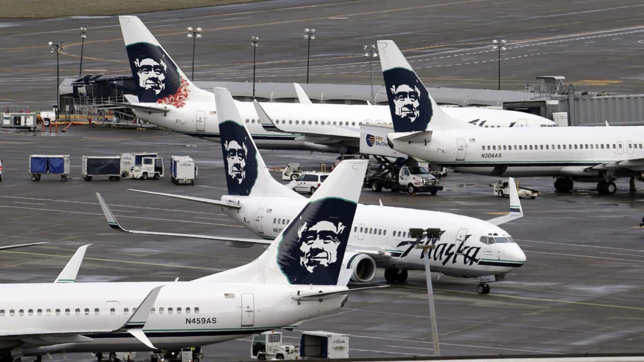 In this photo taken Tuesday, March 24, 2015, an Alaska Airlines jet moves past others already parked at a terminal at Seattle-Tacoma International Airport in SeaTac, Wash. (AP Photo/Elaine Thompson)
