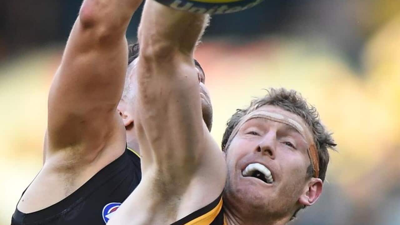 Ben McEvoy of the Hawks (right).