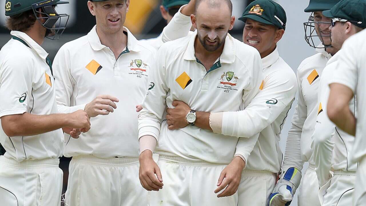 Nathan Lyon (C) celebrates after claiming a wicket