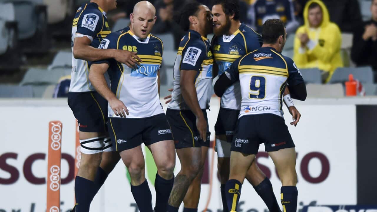ACT Brumbies players celebrate after scoring a try