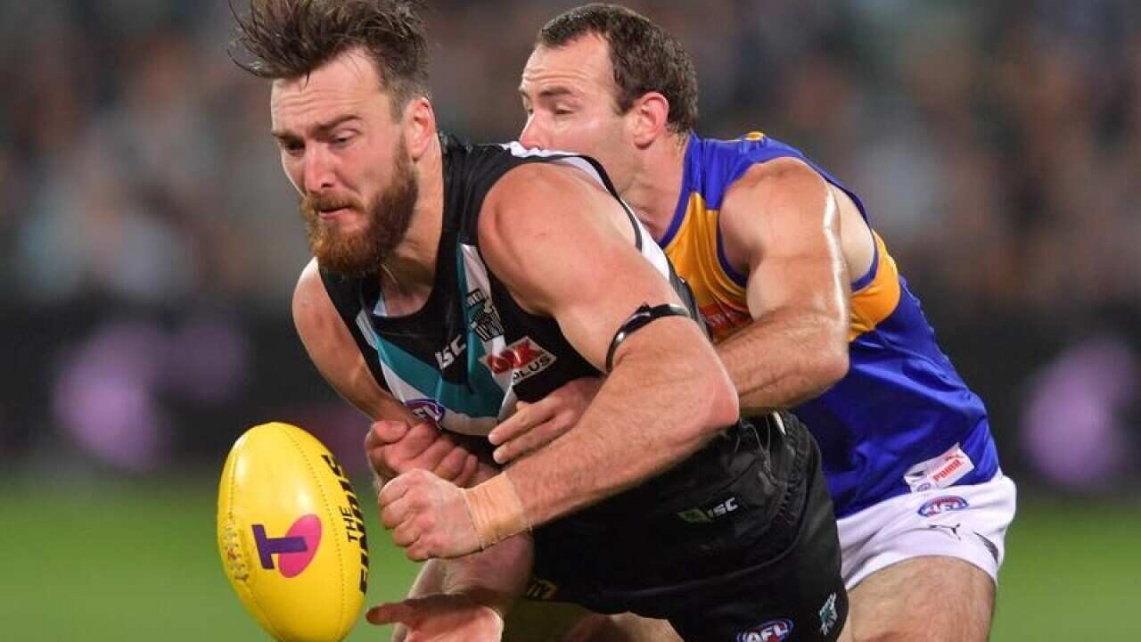 Charlie Dixon of the Power is tacked by an Eagles player.