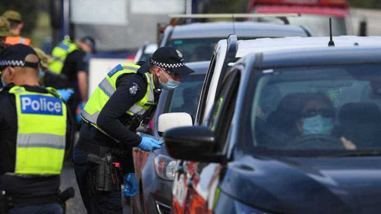 Victoria Police and ADF personnel are seen at work at a roadside checkpoint near Donnybrook, Victoria, on 16 September, 2020. 