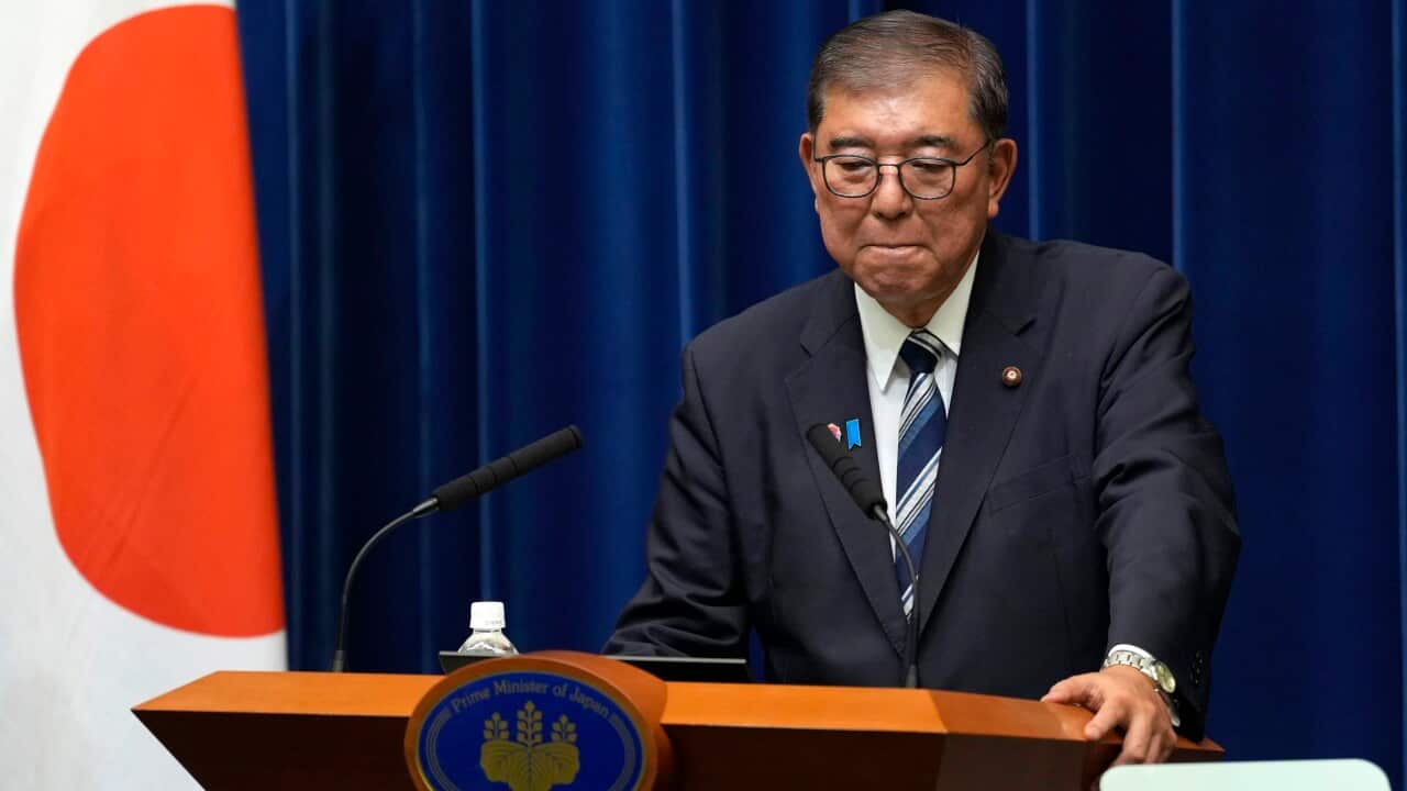 Japan's Prime Minister Ishiba standing behind podium to resign