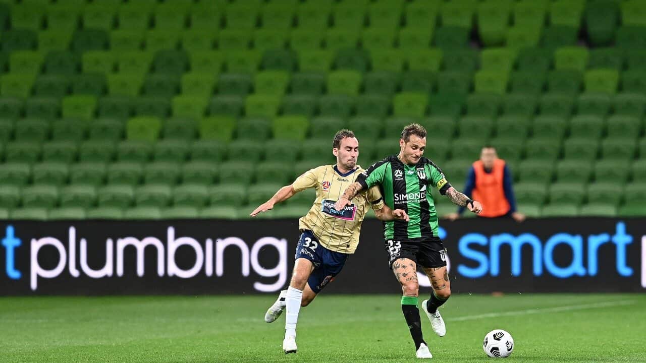 Angus Thurgate of the Jets and Alessandro Diamanti of Western United compete for the ball in front of near-empty stands at AAMI Park