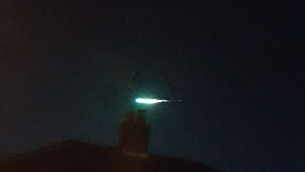 The green meteor streaking across the sky