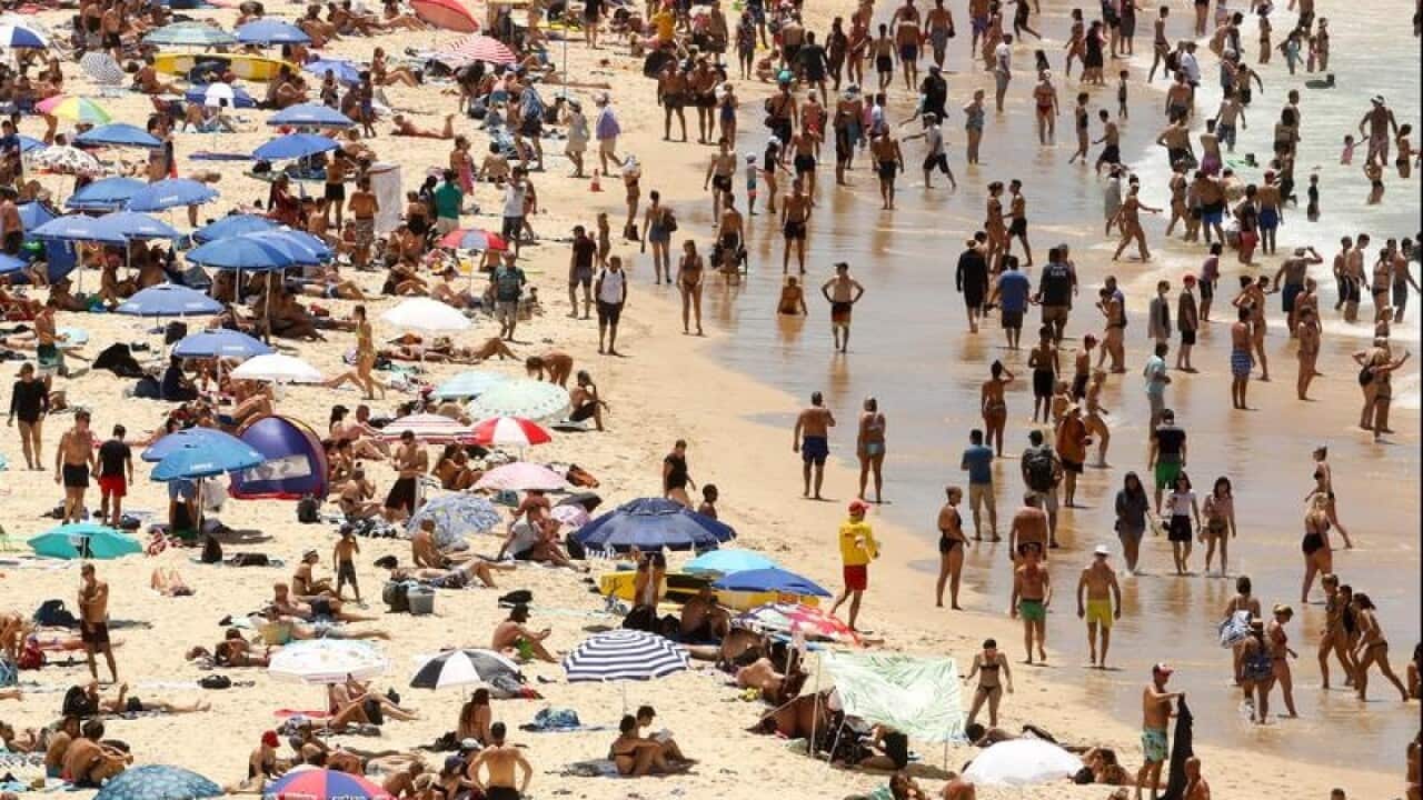 Beachgoers are seen on Bondi beach in Sydney