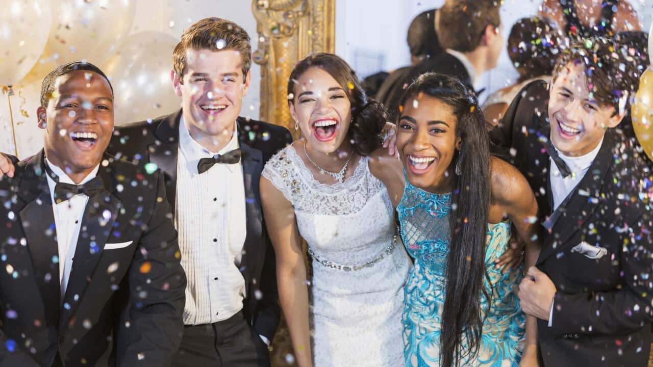 Teenagers and young adults in formalwear at party