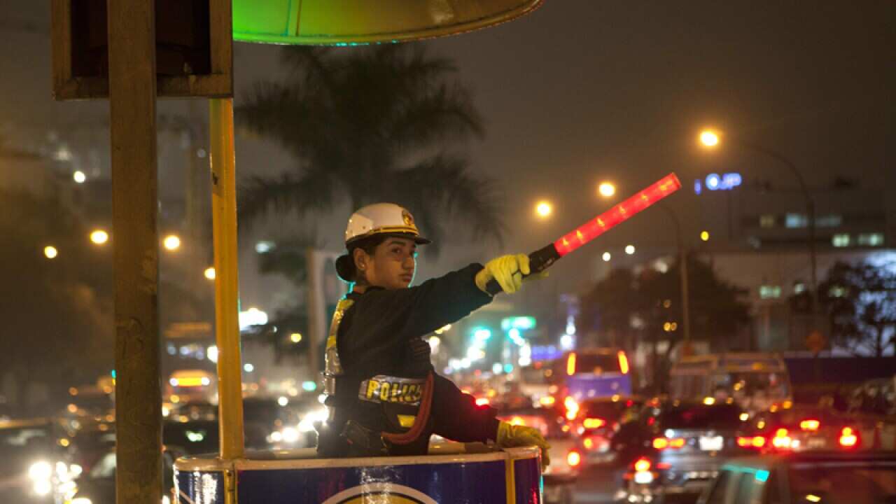 traffic policewoman directs commuters, Peru