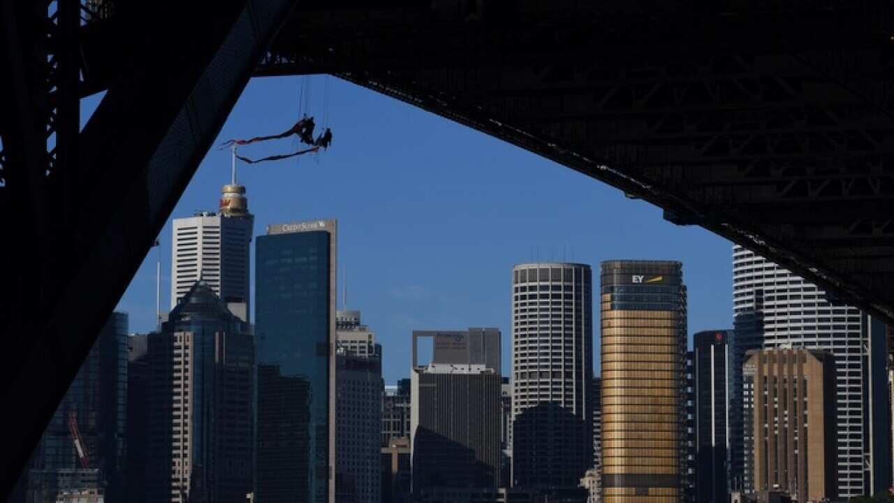 Greenpeace activists can be seen suspended from the under-carriage of the Sydney Harbour Bridge