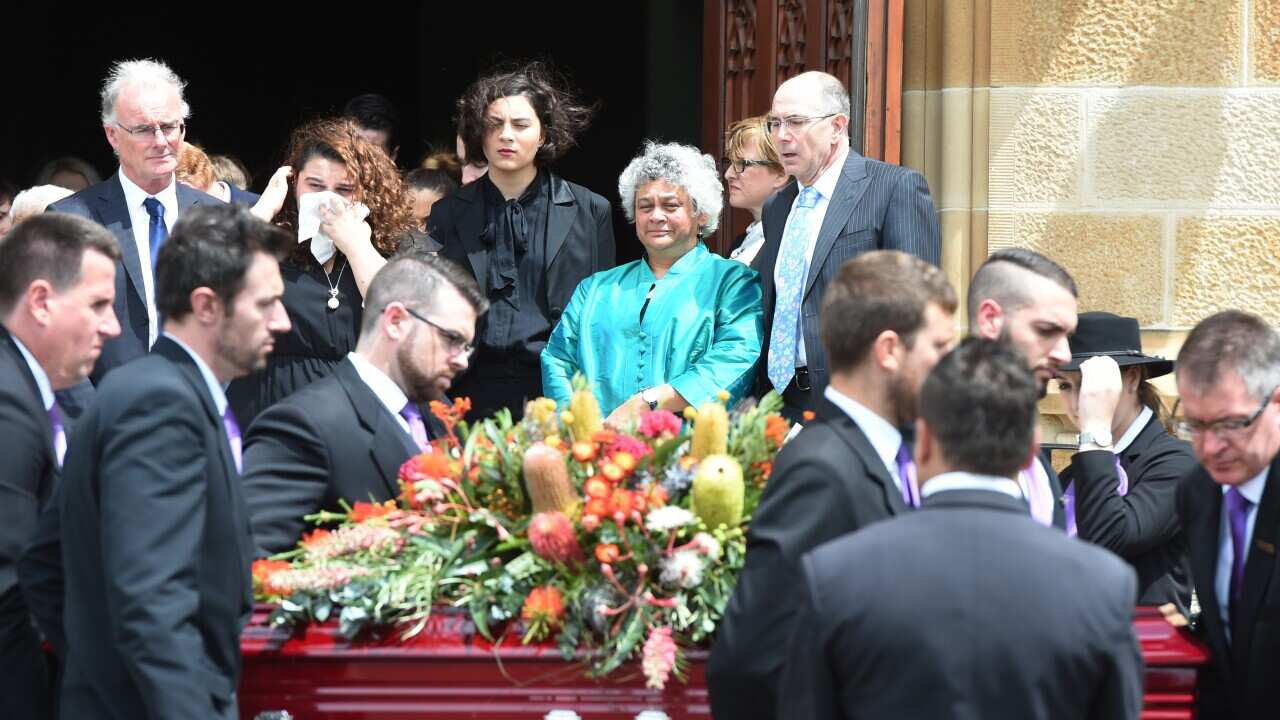 Daughter Lilon Bandler (in blue) watches as the casket of Faith Bandler is carried from The Great Hall at Sydney University following her State Funeral, Sydney, Tuesday, Feb. 24, 2015. (AAP Image/Dean Lewins) NO ARCHIVING