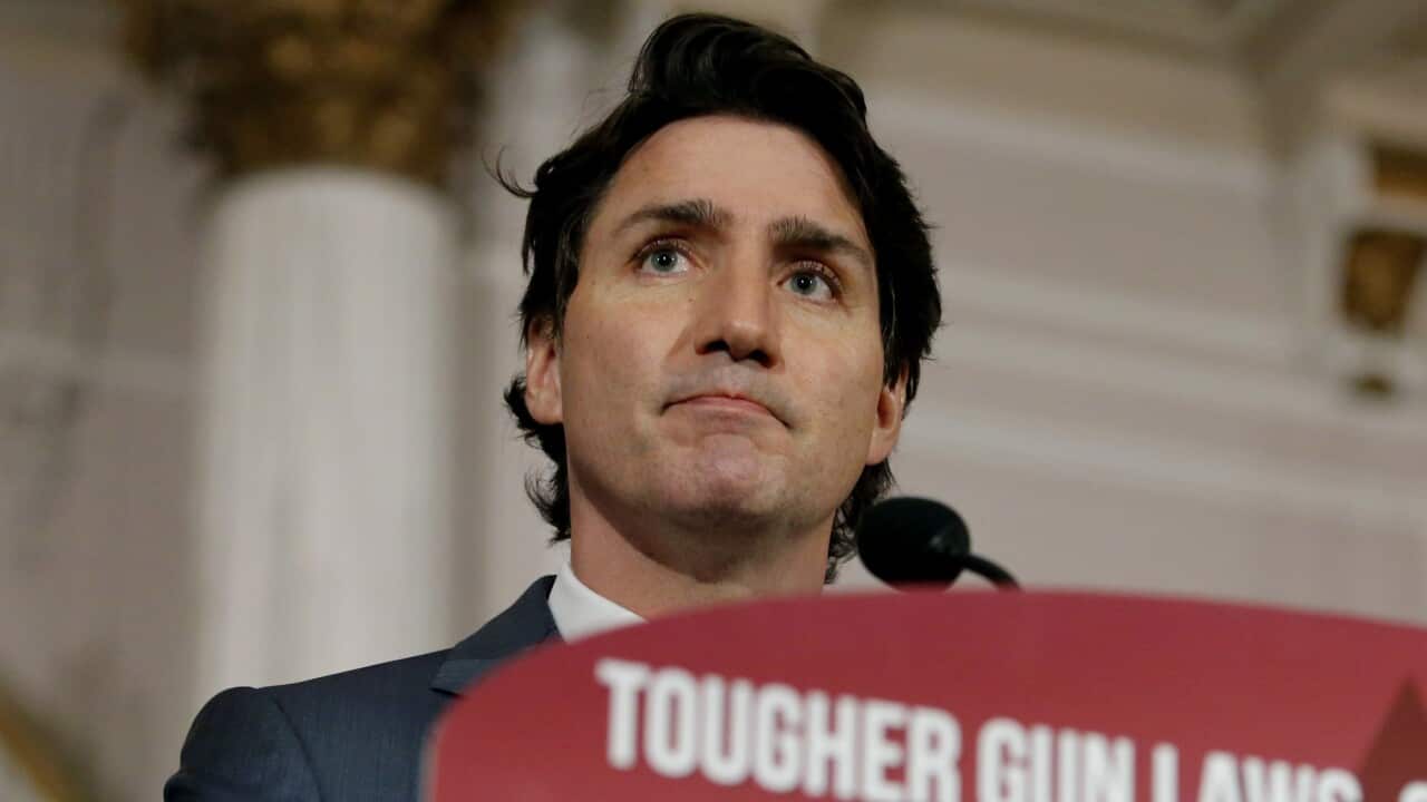 Canada's Prime Minister Justin Trudeau stands at a podium to announce new gun control legislation