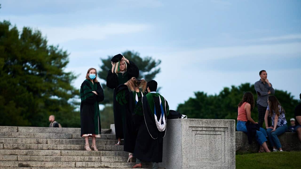 In this photo provided by Geoff Livingston, Georgetown University students and others gather for their own graduation celebration at the National Mall in Washington, Saturday, May 16, 2020. (Geoff Livingston via AP)