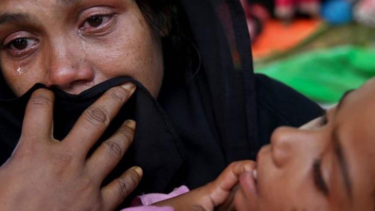 A women is holding her baby