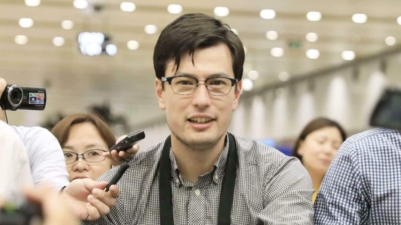 Alek Sigley arriving in China after being released by North Korea.