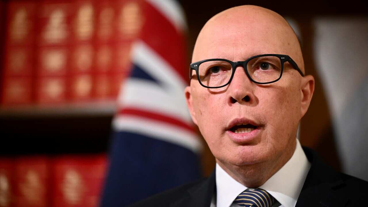 A bald man wearing glasses