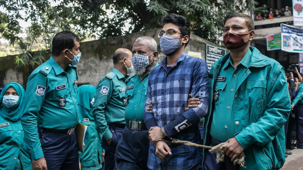 Police officers escort one of the 20 convicted university students out of court after their sentence to death for the brutal 2019 murder of a young man.