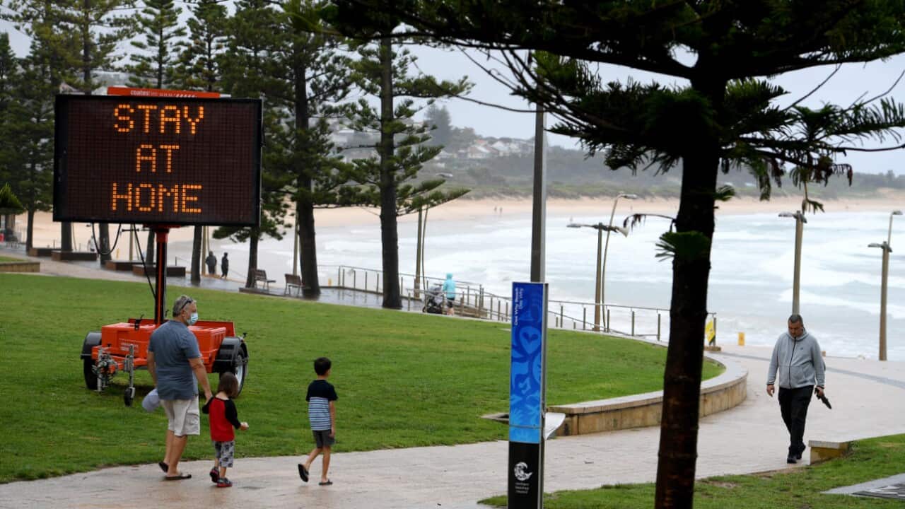 Public health messaging is seen on temporary signage at Dee Why on Sydney’s Northern Beaches, Saturday, 19 December, 2020.