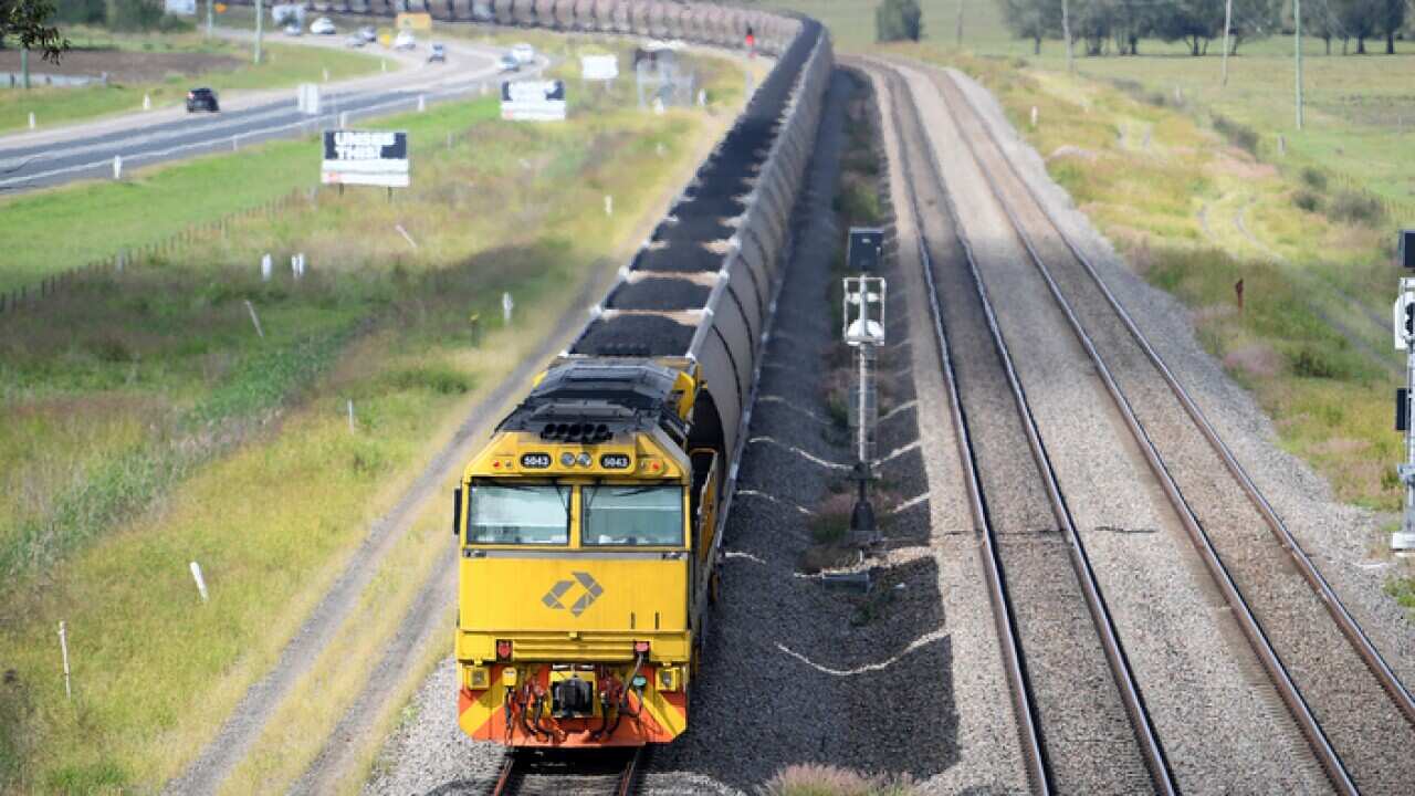 A loaded coal train passes through the outskirts of Singleton, in the NSW Hunter Valley