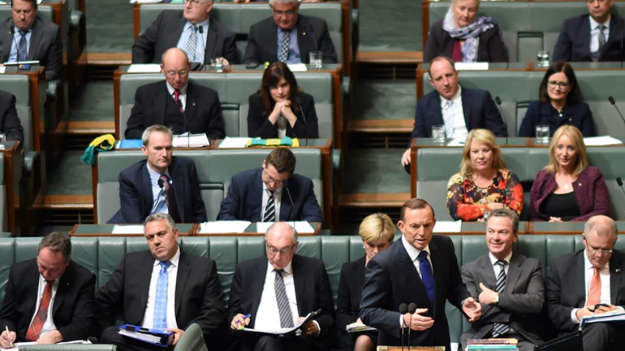 Tony Abbott with government MPs in the House of Representatives