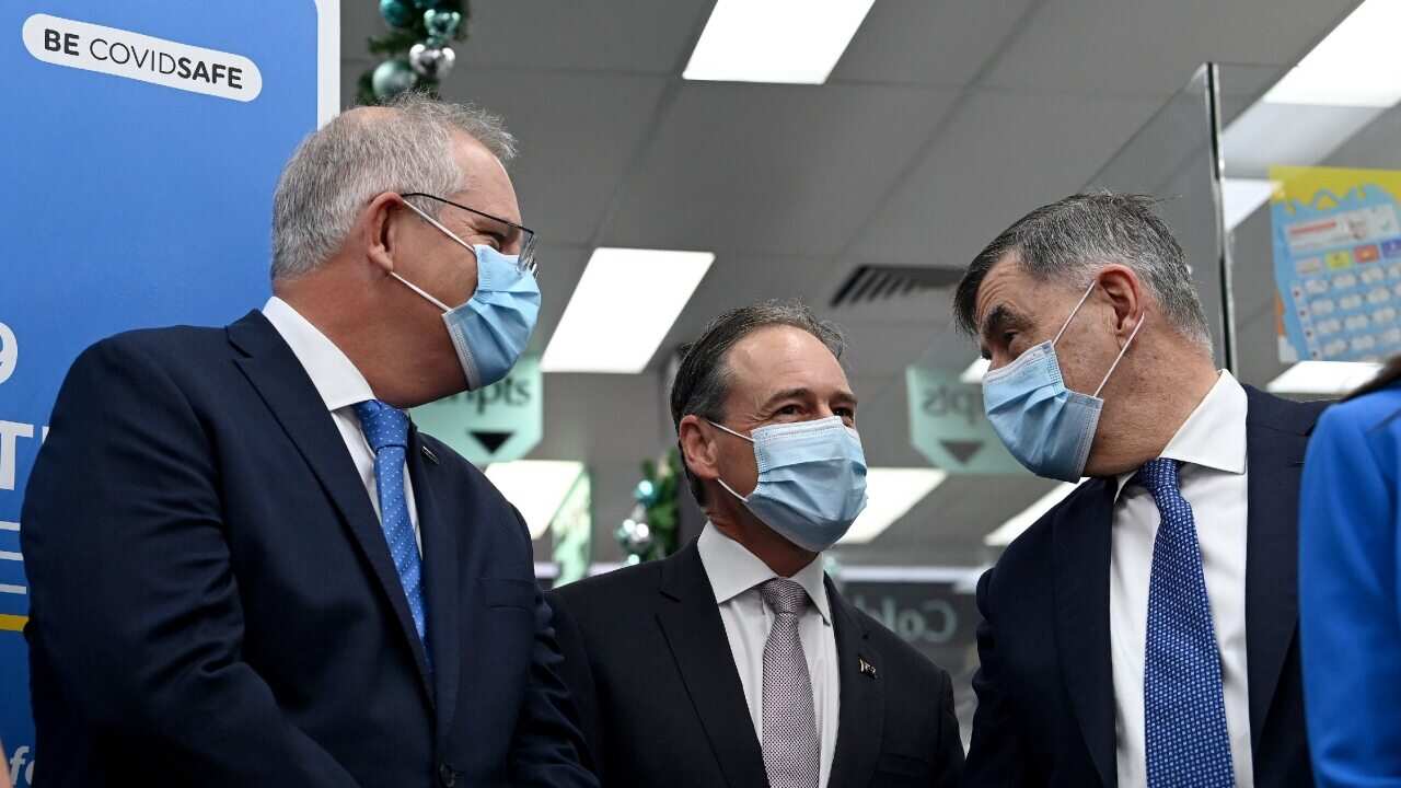 Prime Minister Scott Morrison, Health Minister Greg Hunt and Secretary of the Department of Health Brendan Murphy on 10 December 2021.