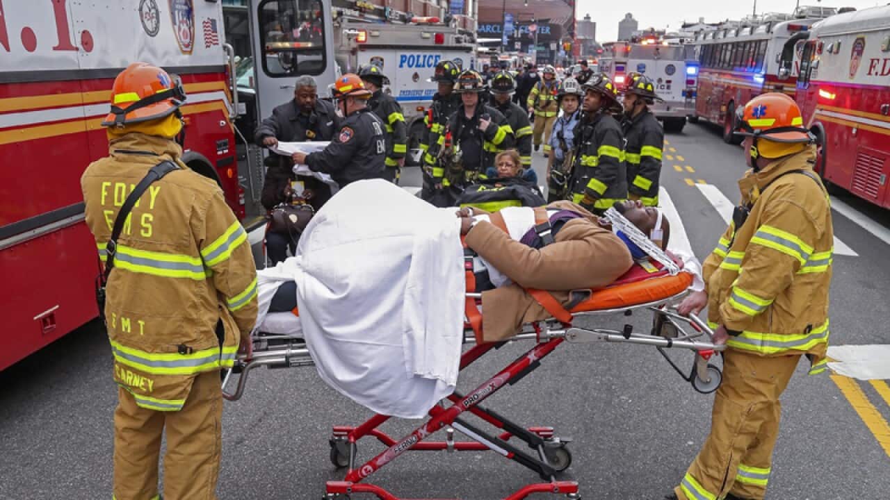 New York City Fire Department personnel treat injured passengers