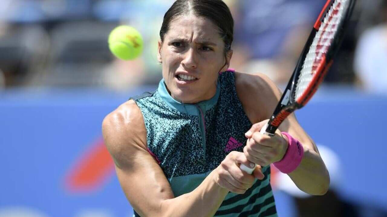 Andrea Petkovic, of Germany, returns the ball against Sloane Stephens.