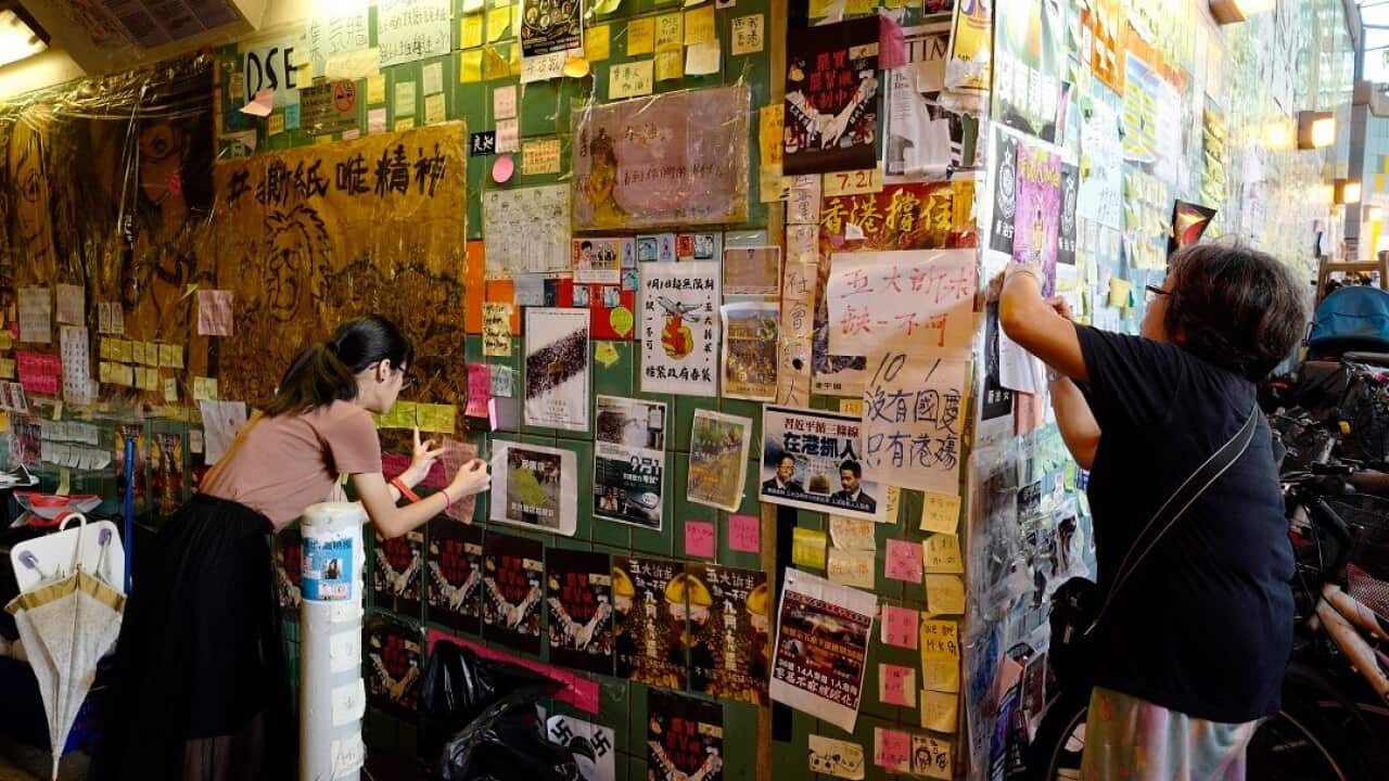 Local residents attach messages on a Lennon Wall near the Tai Po Market station in Hong Kong.