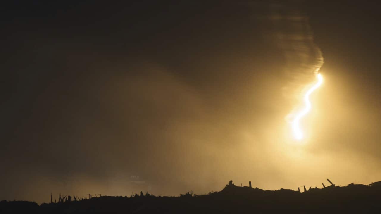 An Israeli army flare drifts over an area in the northern Gaza Strip