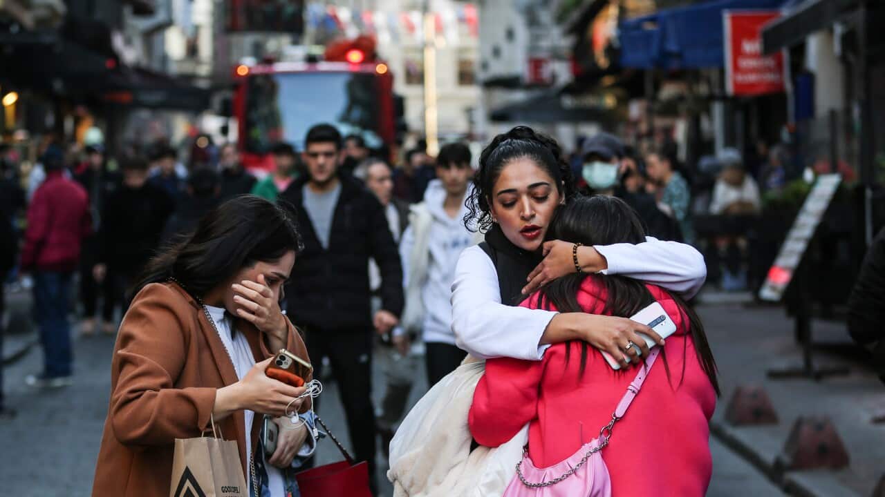 Two women hug at the scene of the explosion in Istanbul