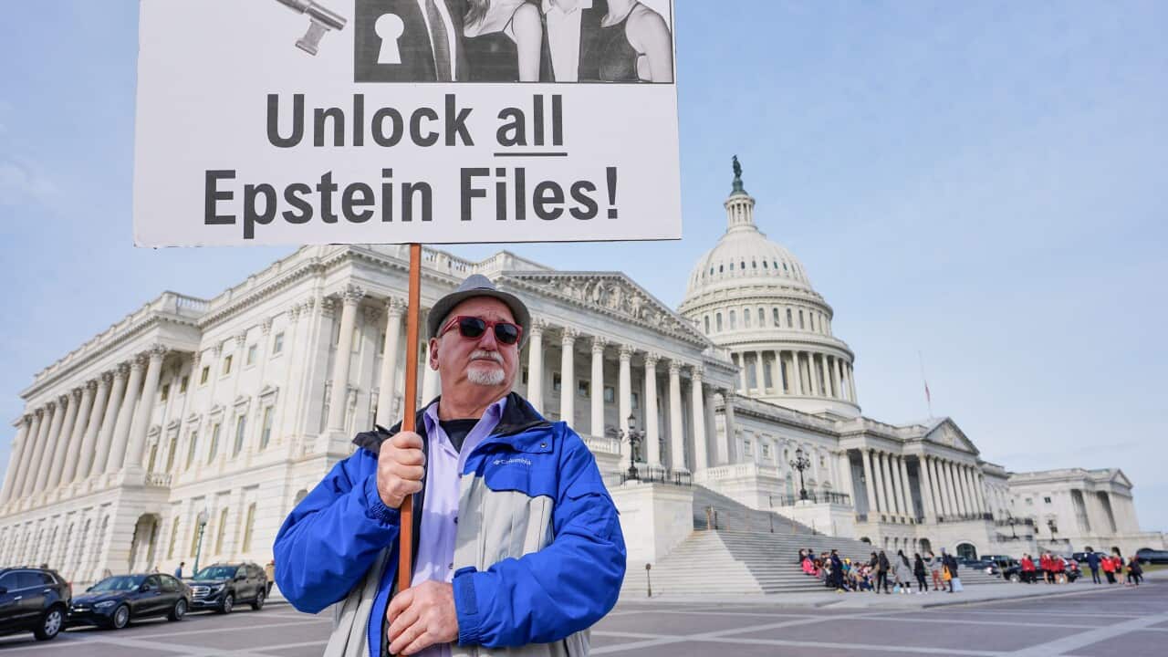 Gary Rush, College Park, MD, holds a sign before a news conference on the Epstein files in front of the Capitol, Tuesday, Nov. 18, 2025, in Washington.