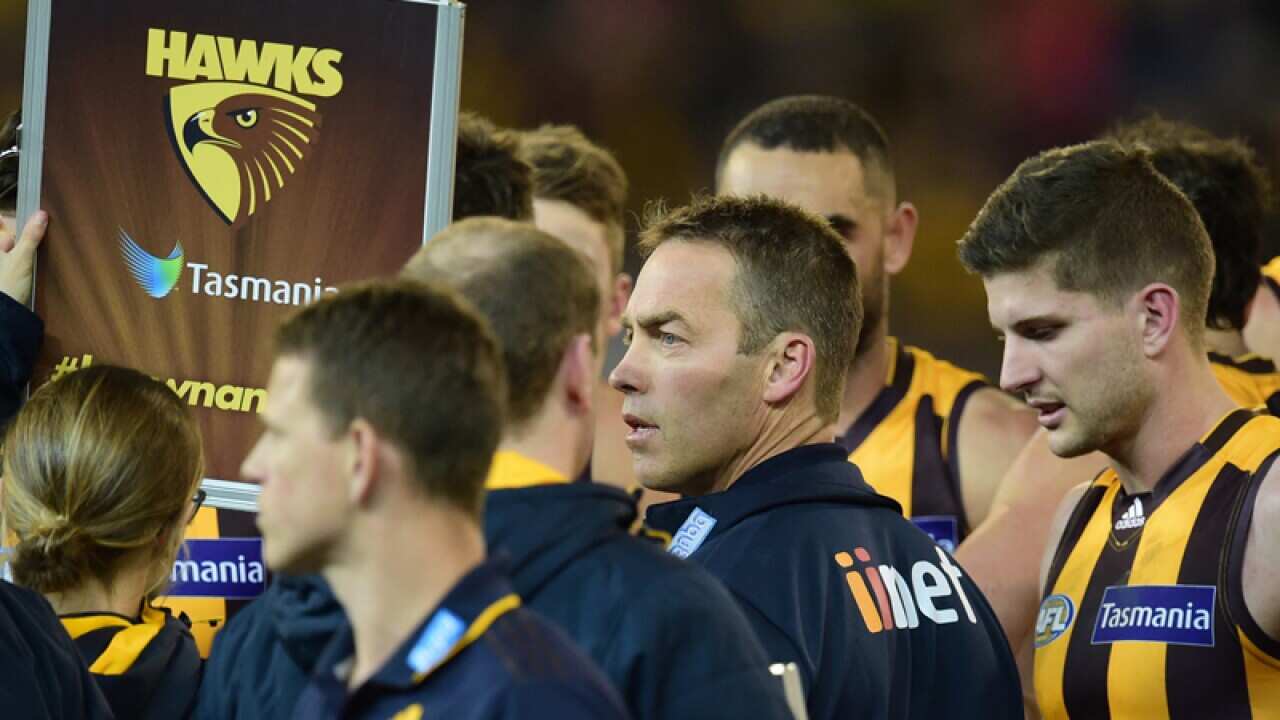 Hawthorn coach Alastair Clarkson speaks to his players