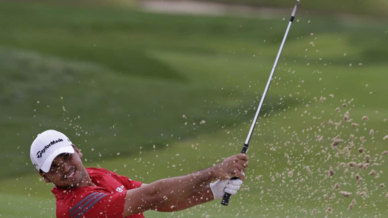 Jason Day, of Australia, hits out of the bunker