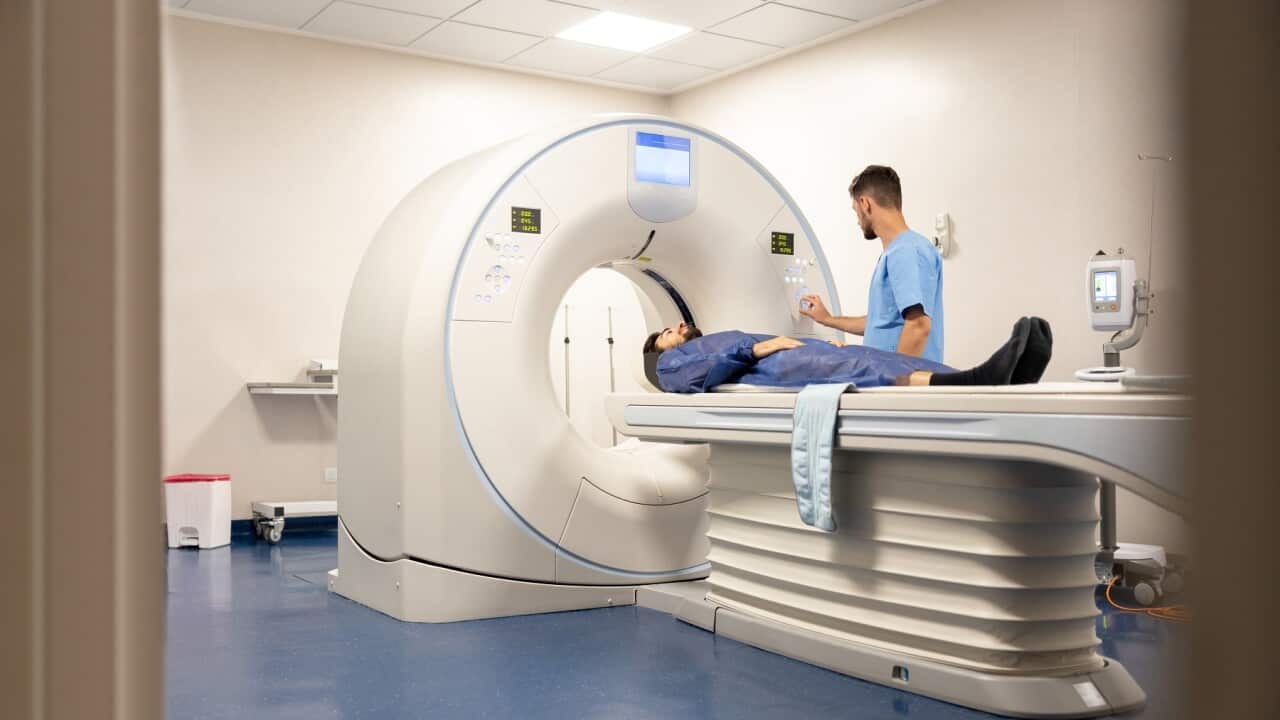 Doctor getting a patient ready for a medical scan at the hospital