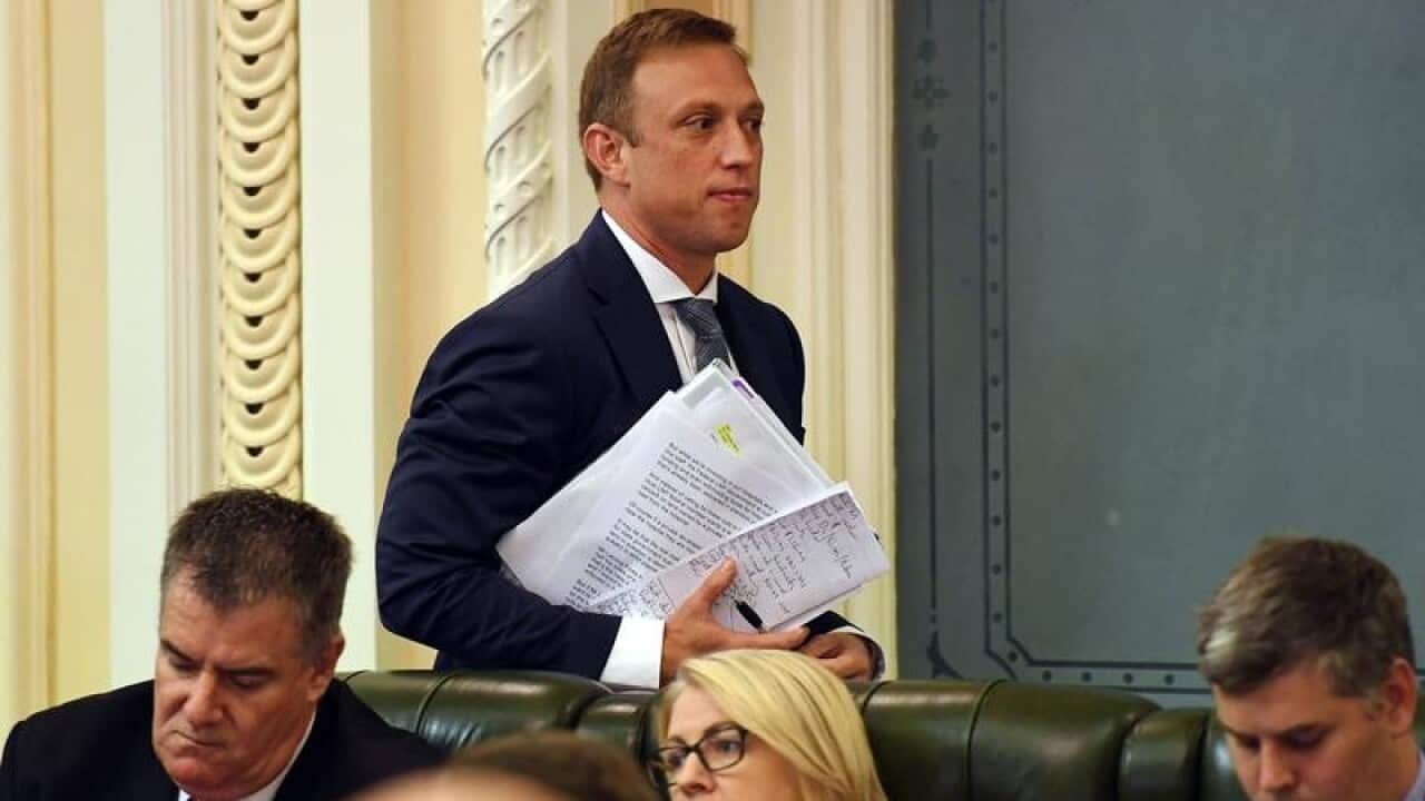 Queensland Health Minister Steven Miles (standing) in state parliament