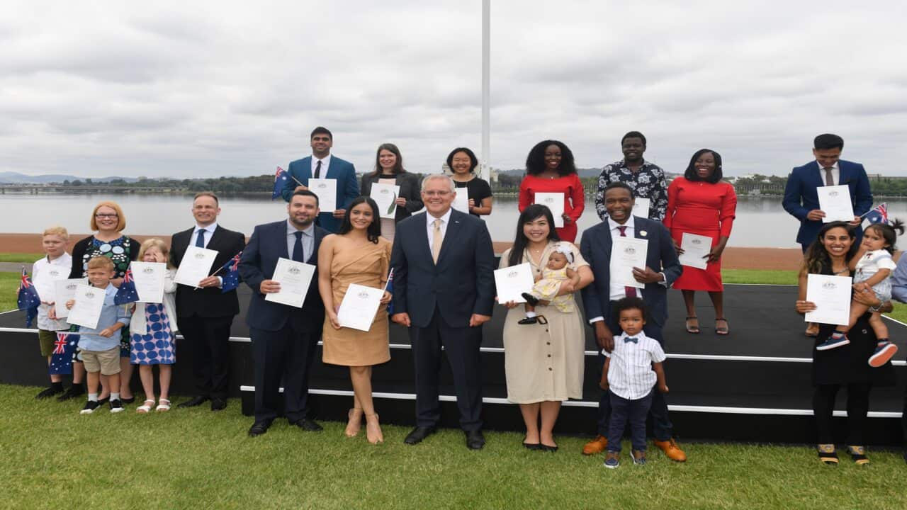 Prime Minister Scott Morrison poses with new citizens during the National Australia Day Flag Raising and Citizenship Ceremony in Canberra, Wednesday, January 26, 2022. (AAP Image/Mick Tsikas) NO ARCHIVING