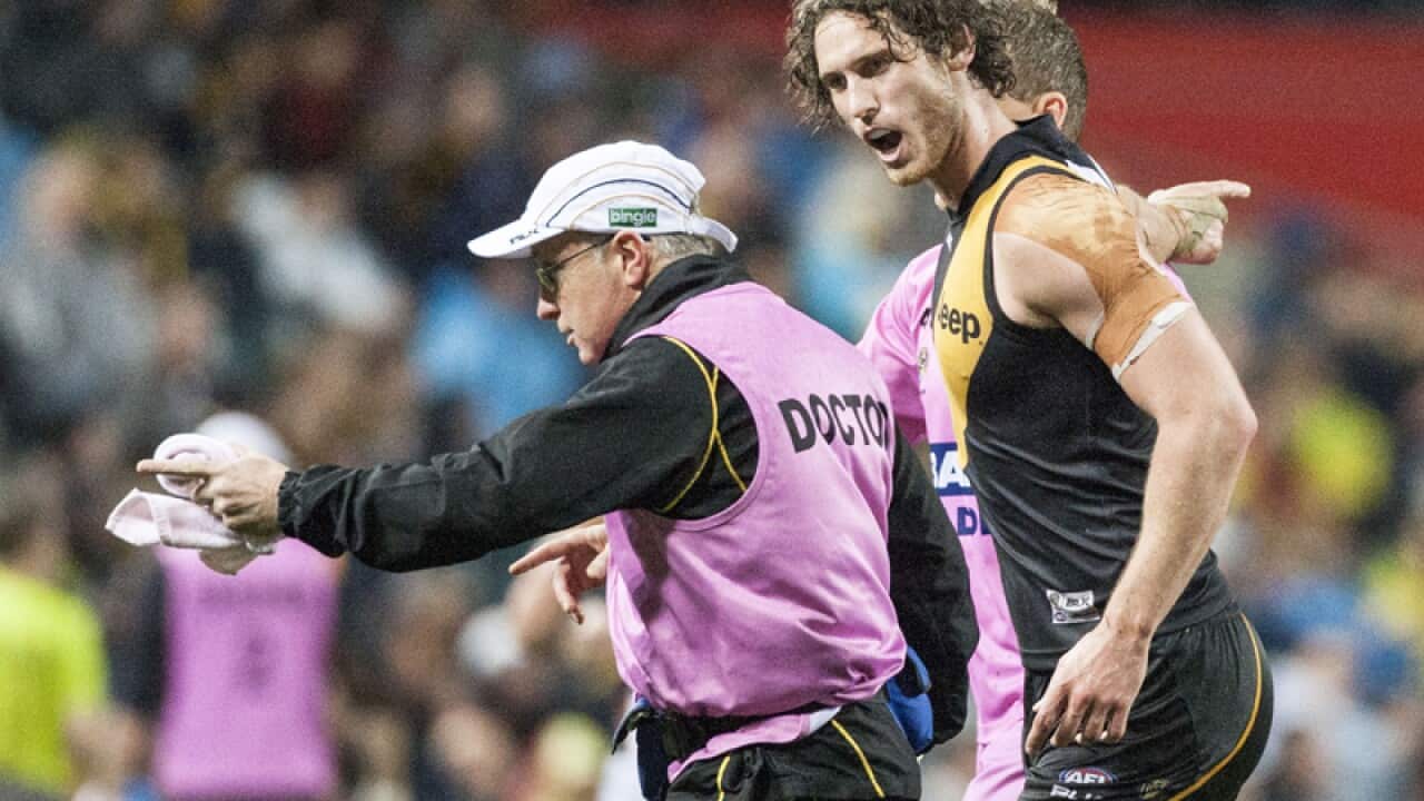 Ty Vickery of Richmond is taken from the field