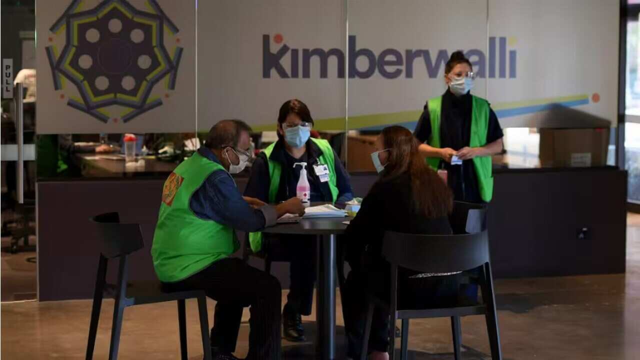 A person consulting with a doctor and nurse at the Kimberwalli Aboriginal Covid-19 vaccination Hub in Whalan, west of Sydney, in 2021 Source: AAP / DAN HIMBRECHTS