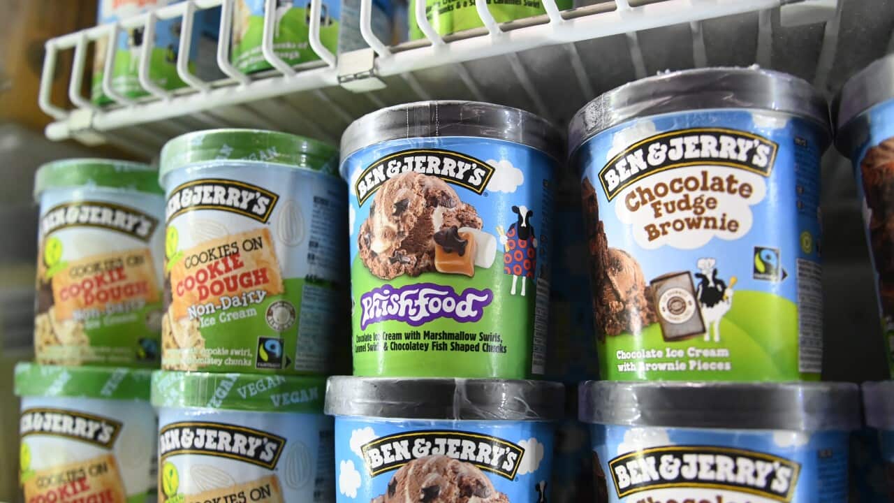 Tubs of Ben & Jerrys ice cream on a freezer shelf.