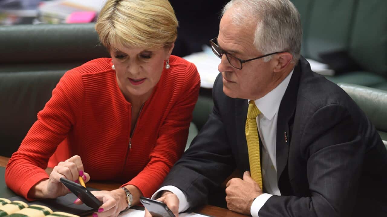 Julie Bishop and Malcolm Turnbull use their mobile phones