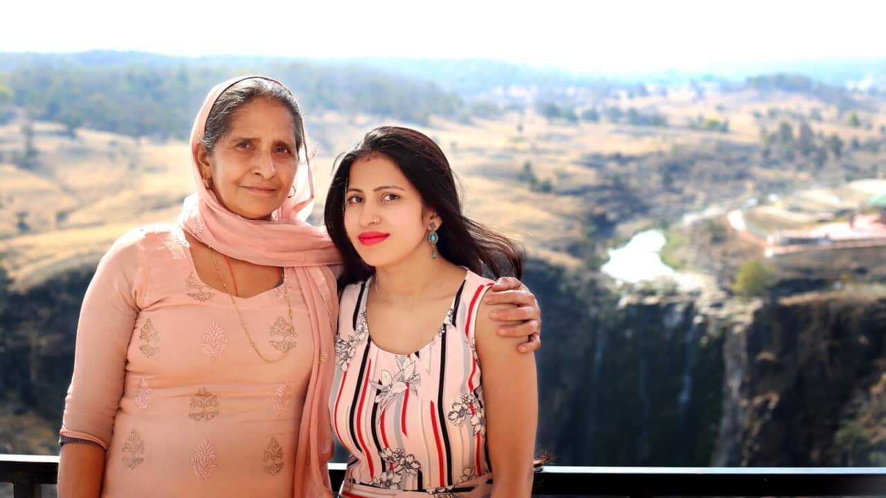 Mother & Daughter standing in house balcony near Patalpani Waterfall